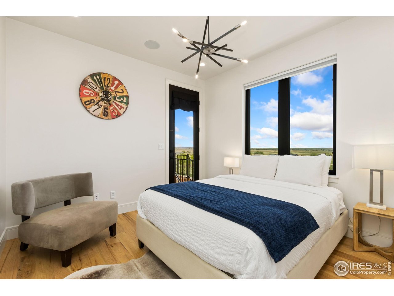 3802 Bridle Ridge Circle Severance, CO 80524 - Photo 23 of 50 a bedroom with a bed and a chandelier