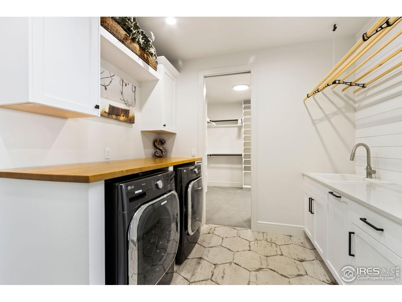 3802 Bridle Ridge Circle Severance, CO 80524 - Photo 27 of 50 a bathroom with a sink a washer and dryer