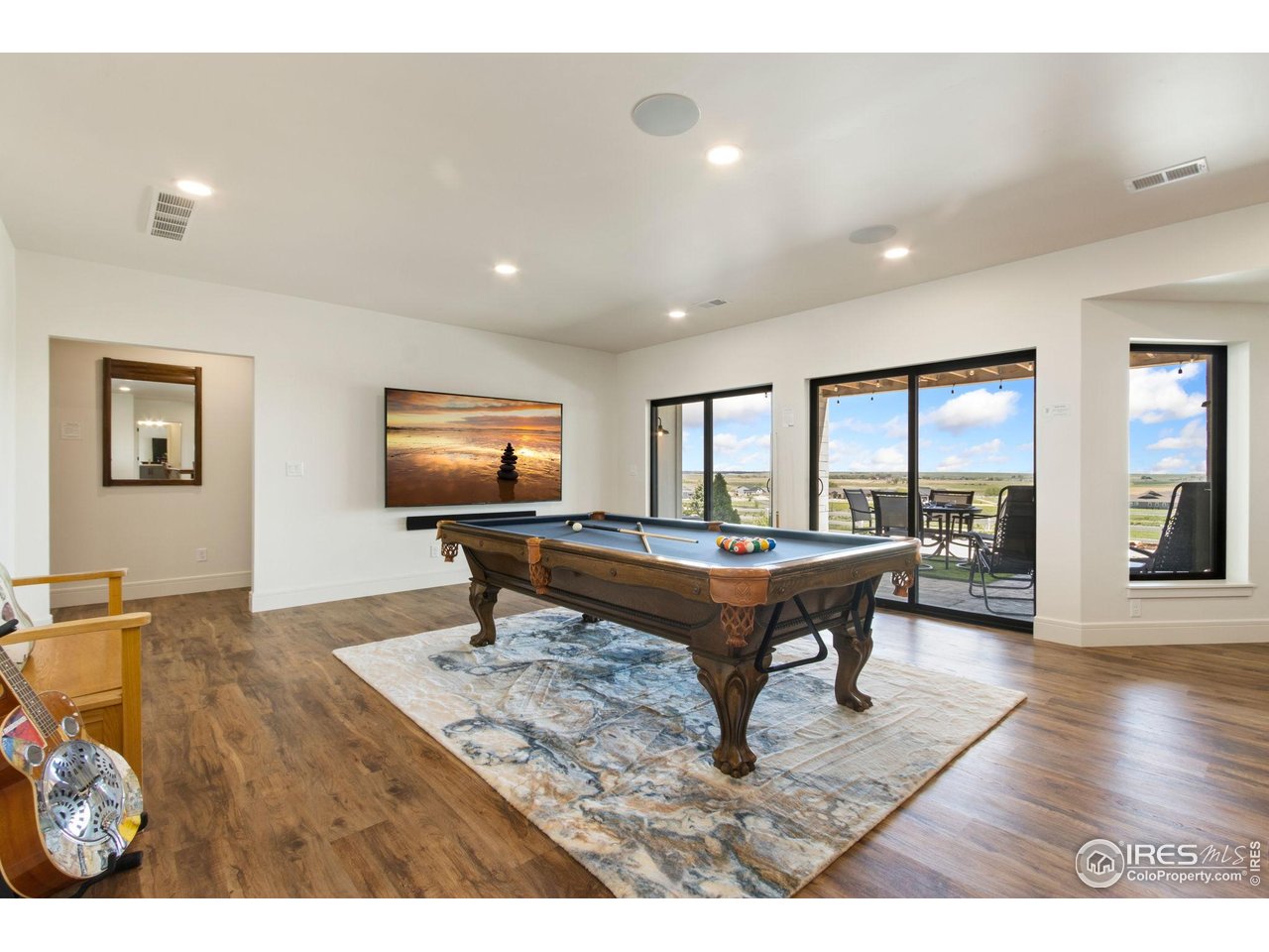 3802 Bridle Ridge Circle Severance, CO 80524 - Photo 31 of 50 a living room with furniture a table and a flat screen tv