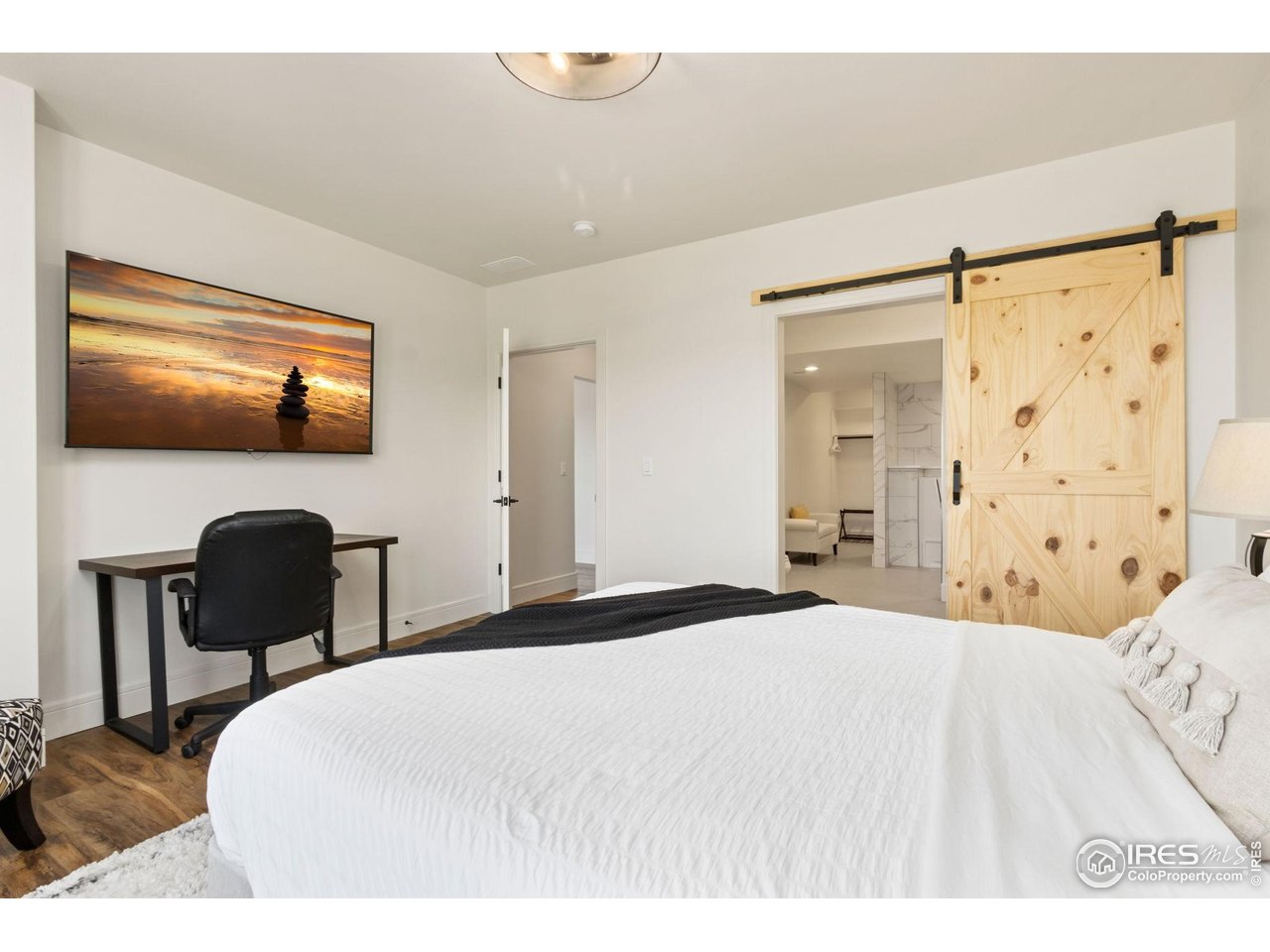 3802 Bridle Ridge Circle Severance, CO 80524 - Photo 39 of 50 a bedroom with a bed and a desk