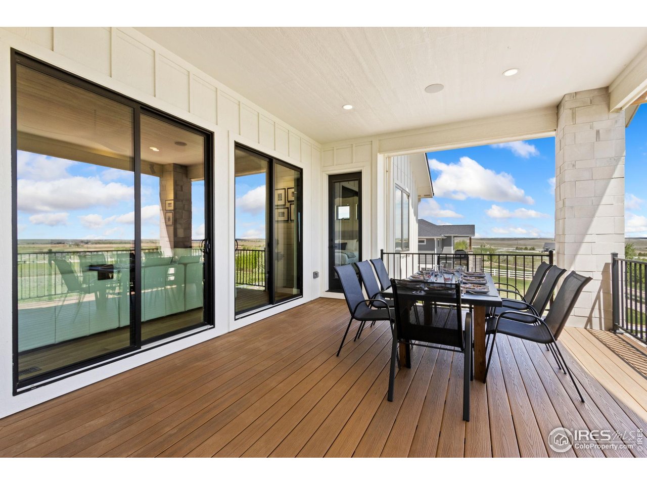 3802 Bridle Ridge Circle Severance, CO 80524 - Photo 46 of 50 a view of a dining room with furniture large windows and wooden floor