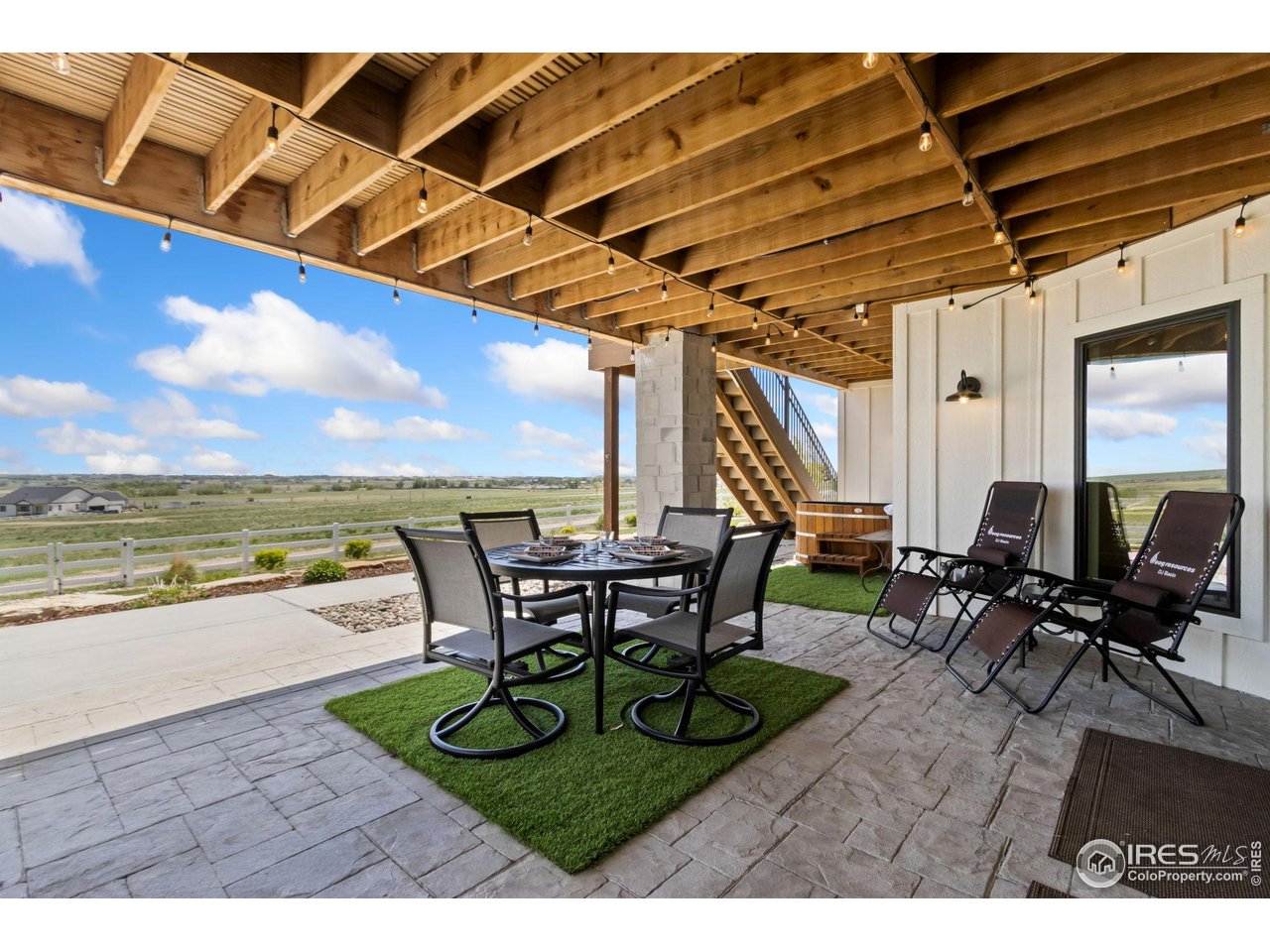 3802 Bridle Ridge Circle Severance, CO 80524 - Photo 47 of 50 a view of a patio with lawn chairs and couches with wooden floor