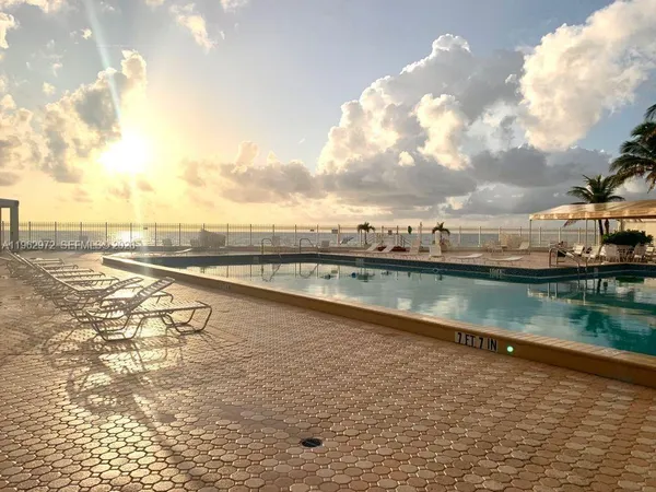 a view of swimming pool with outdoor seating