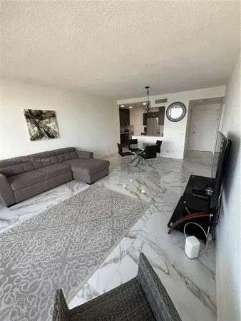 a living room with furniture and a mirror