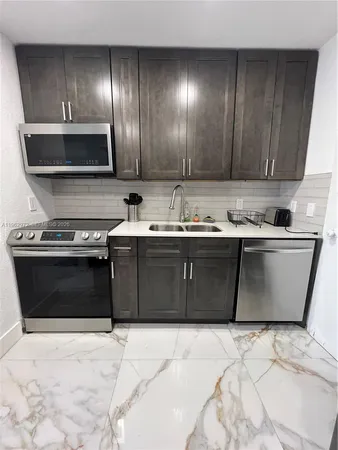 a kitchen with a sink and a stove