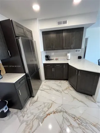 a kitchen with a sink stainless steel appliances and cabinets