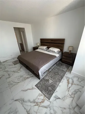 a bedroom with a bed and mirror