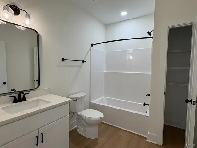 a bathroom with a shower a sink and a toilet