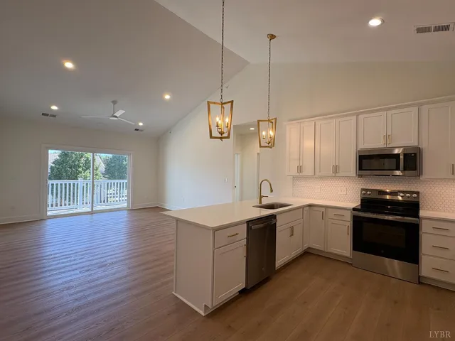 a kitchen with stainless steel appliances granite countertop a sink and stove top oven