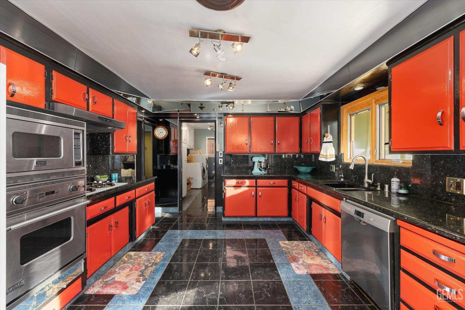 Undisclosed Address Bakersfield, CA 93306 - Photo 19 of 41 a large kitchen with stainless steel appliances granite countertop a stove and cabinets