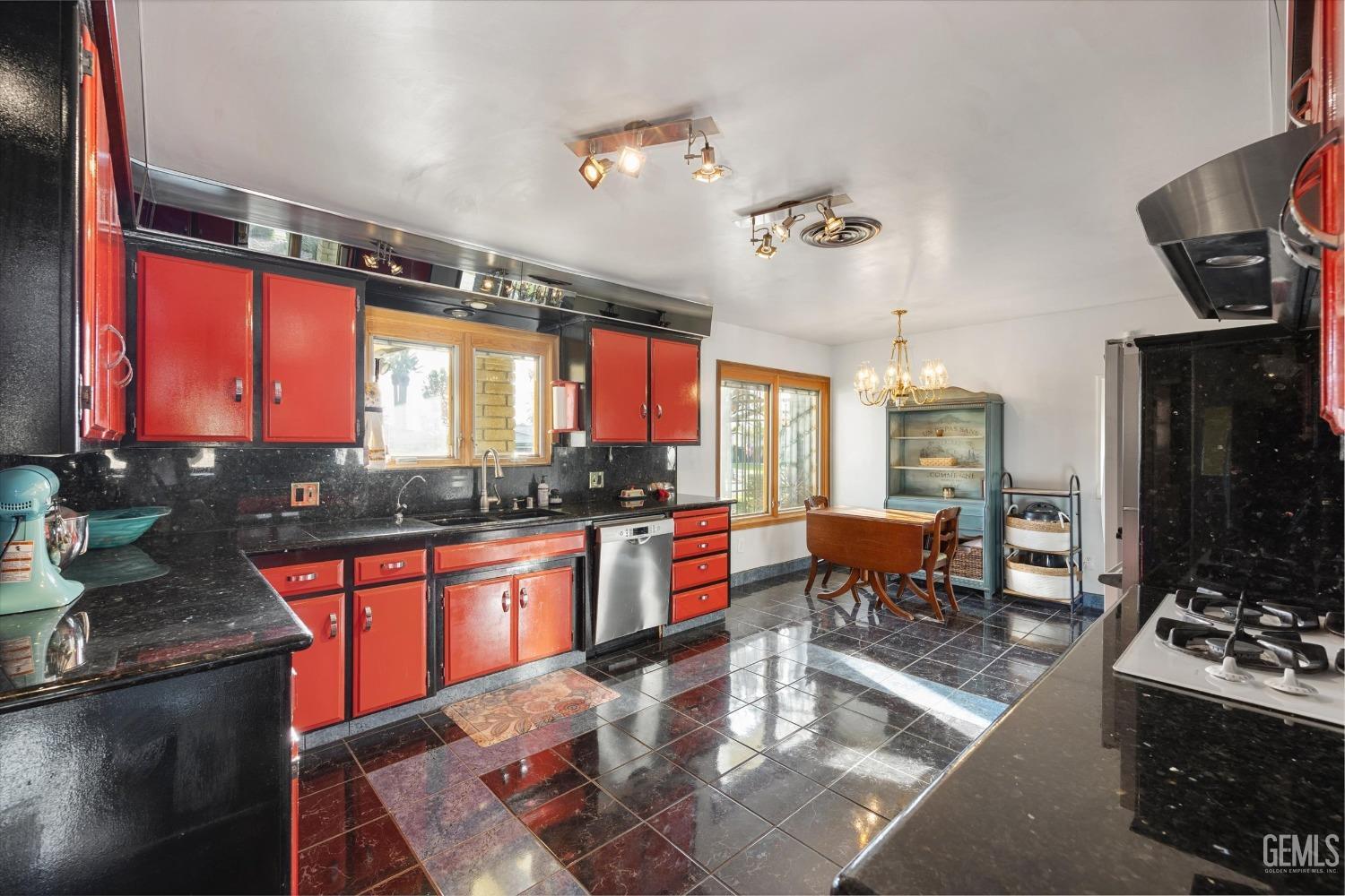 Undisclosed Address Bakersfield, CA 93306 - Photo 21 of 41 a kitchen with stainless steel appliances granite countertop a stove and a view of living room