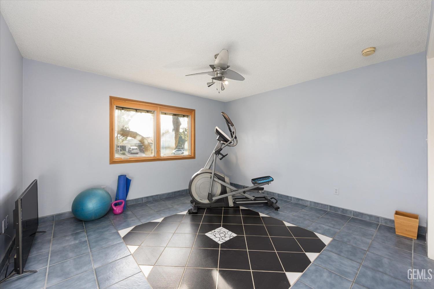 Undisclosed Address Bakersfield, CA 93306 - Photo 32 of 41 a room with gym equipment and a rug