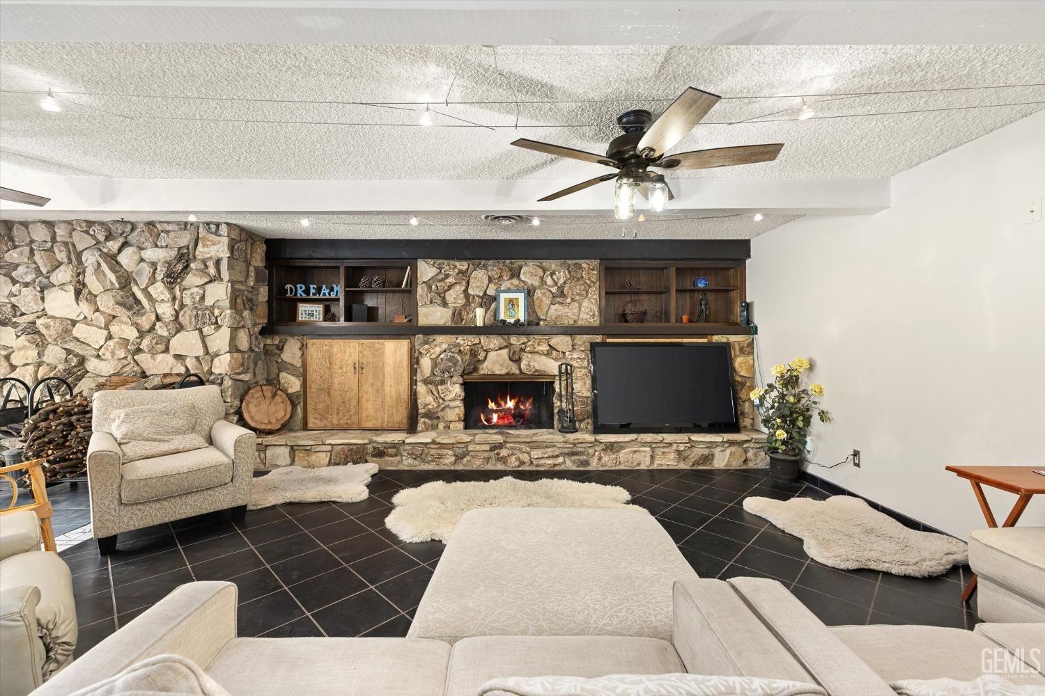 Undisclosed Address Bakersfield, CA 93306 - Photo 10 of 41 a living room with furniture and a fireplace