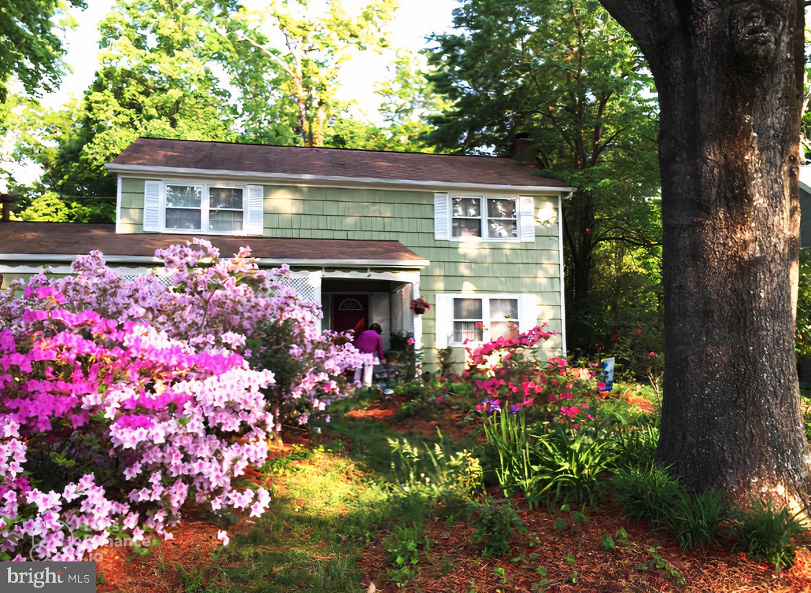 a front view of house and flowers