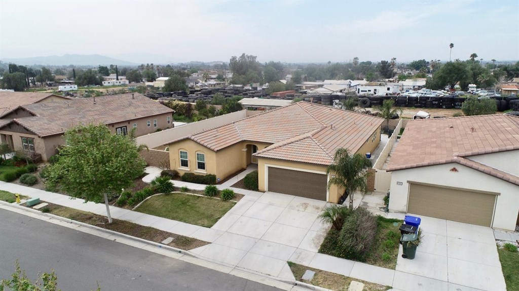 an aerial view of a house with a yard and lake view