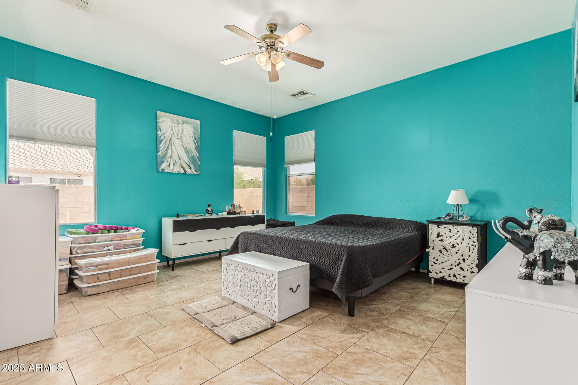 3318 West Latona Road Laveen, AZ 85339 - Photo 10 of 26 a bedroom with a bed and a chandelier