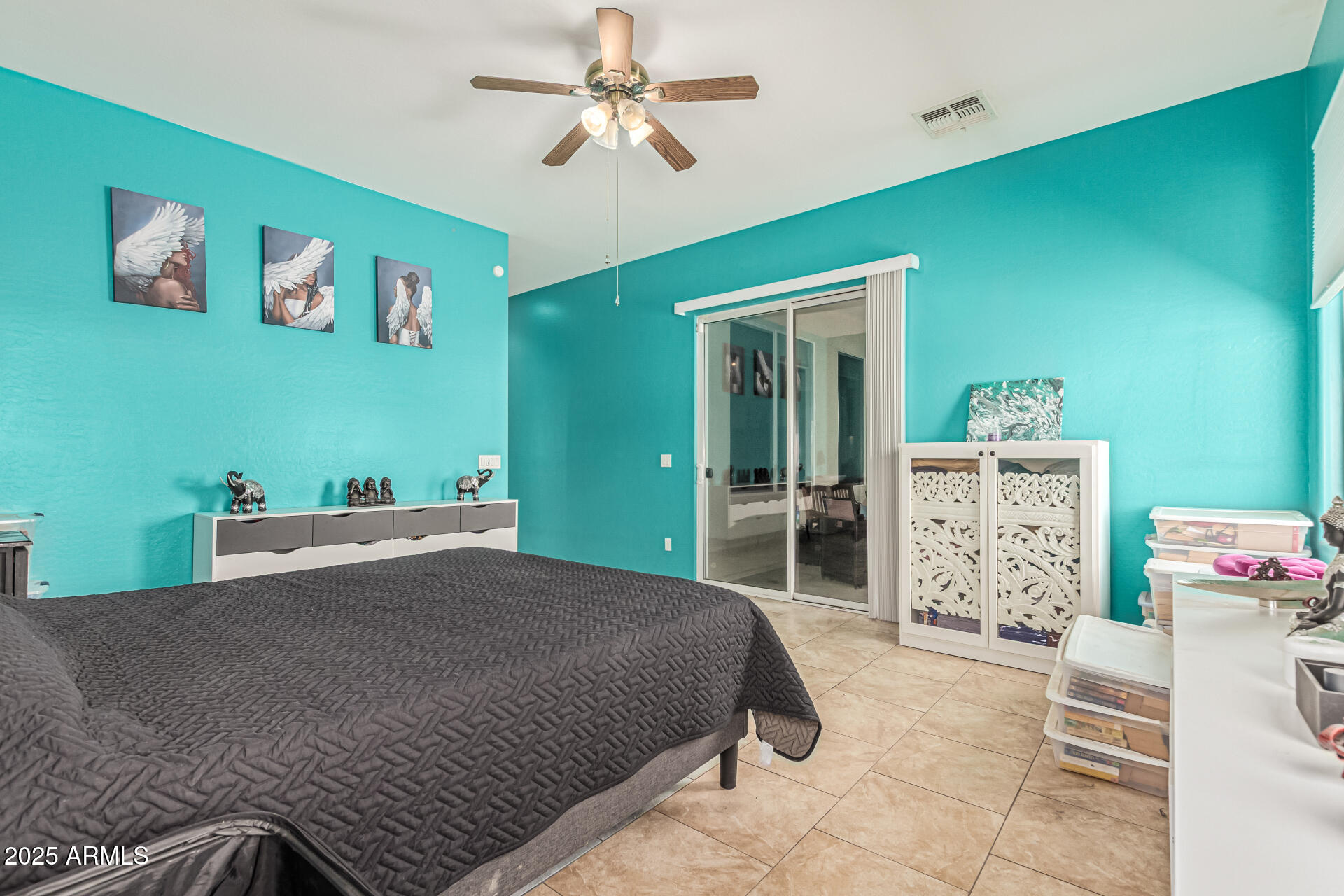 3318 West Latona Road Laveen, AZ 85339 - Photo 11 of 26 a bedroom with a bed and a chandelier