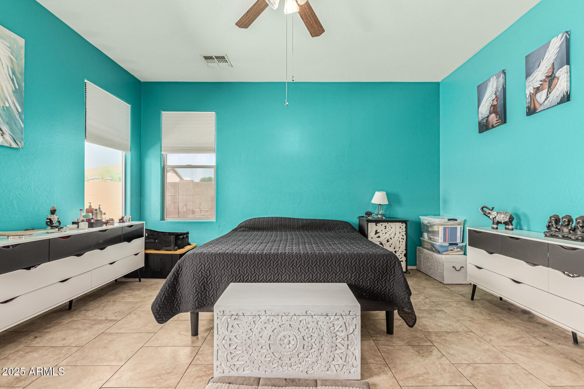 3318 West Latona Road Laveen, AZ 85339 - Photo 12 of 26 a bedroom with a bed and a chandelier