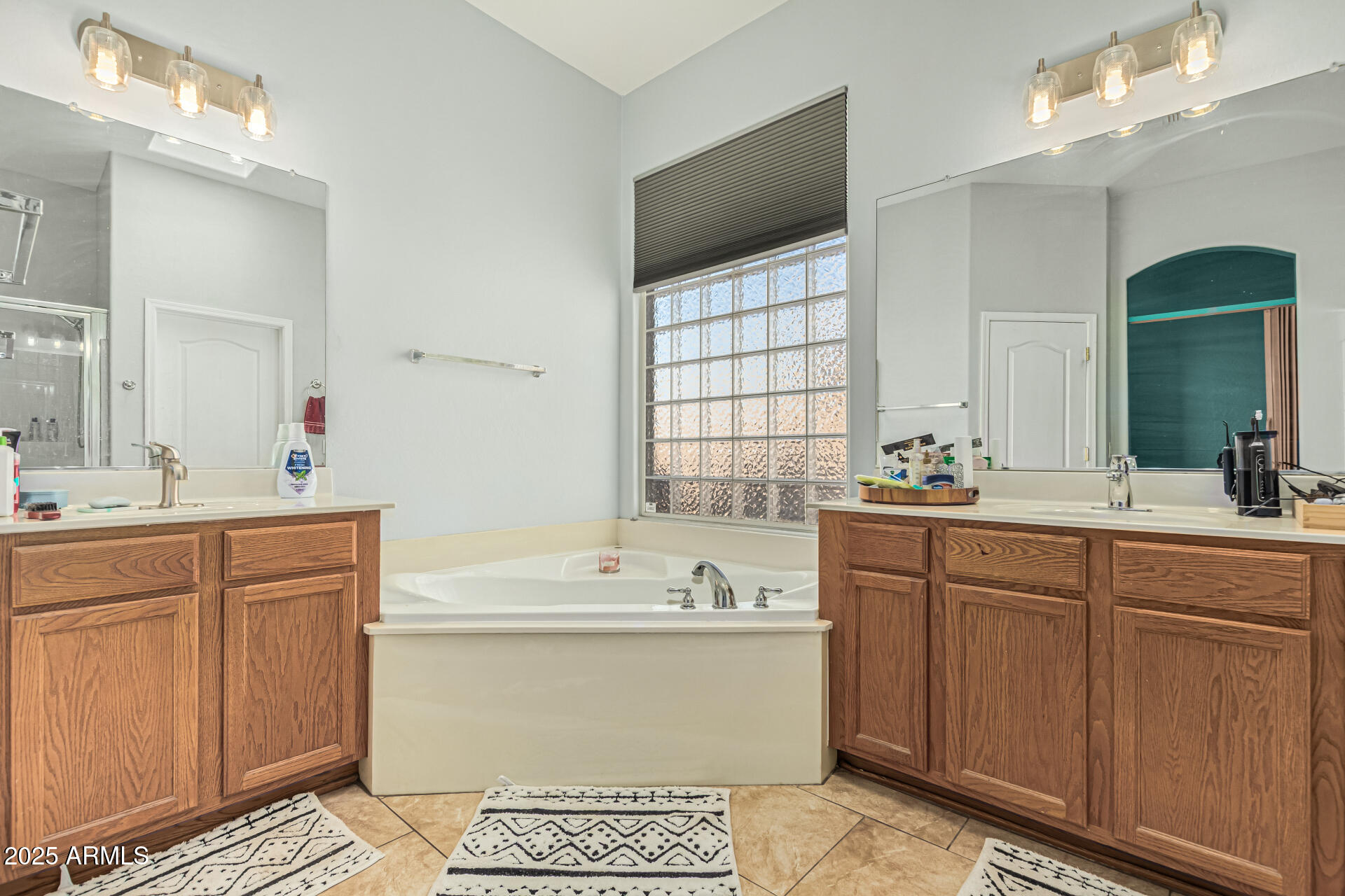 3318 West Latona Road Laveen, AZ 85339 - Photo 13 of 26 a spacious bathroom with a double vanity sink mirror and bathtub