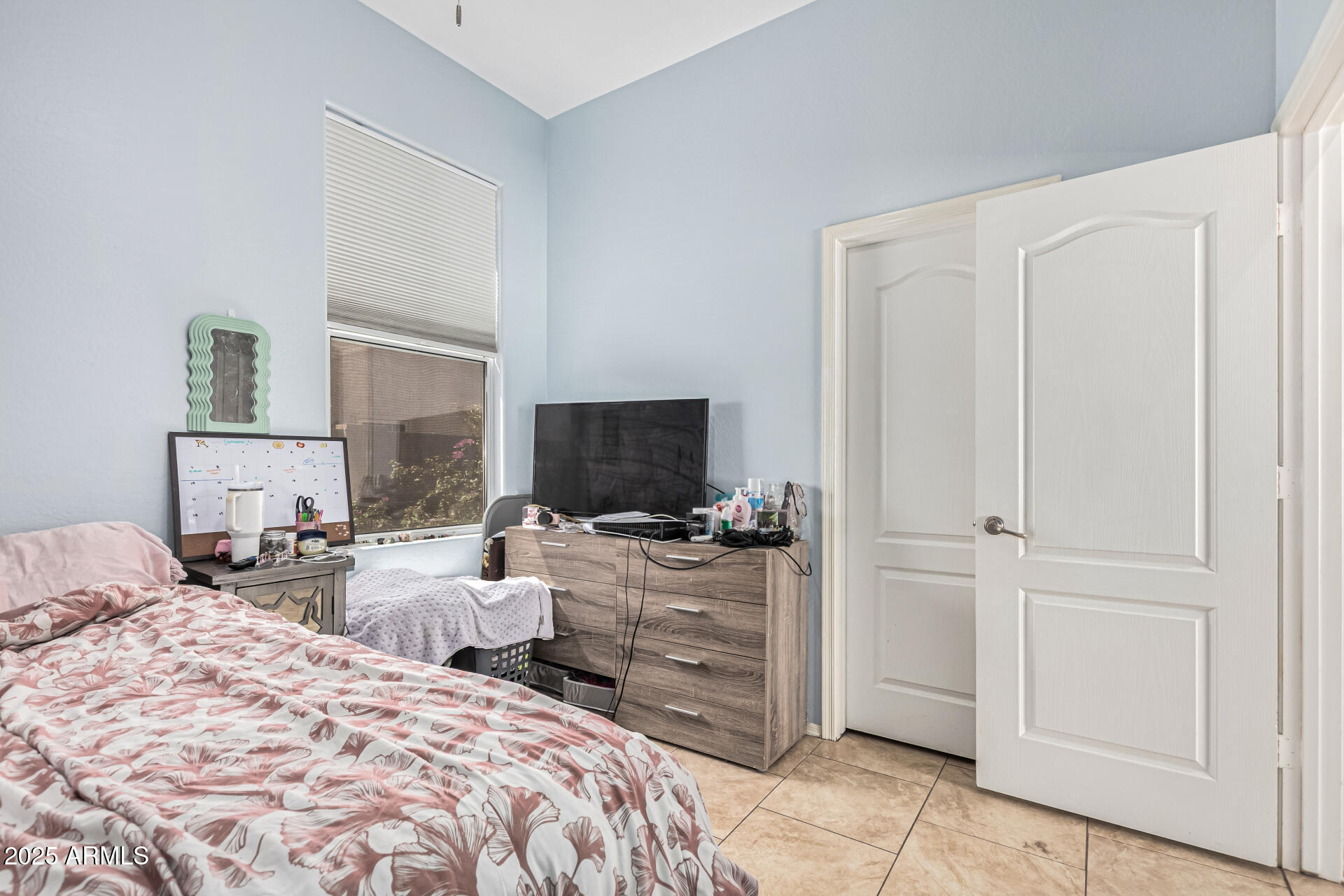 3318 West Latona Road Laveen, AZ 85339 - Photo 17 of 26 a bedroom with two beds and a television