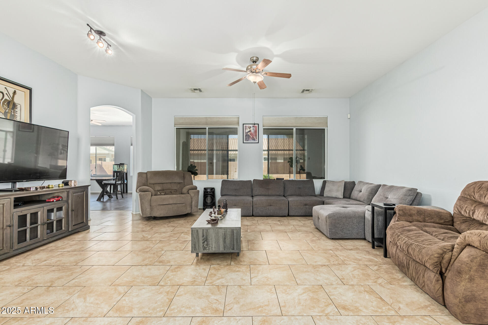 3318 West Latona Road Laveen, AZ 85339 - Photo 2 of 26 a living room with furniture and a flat screen tv