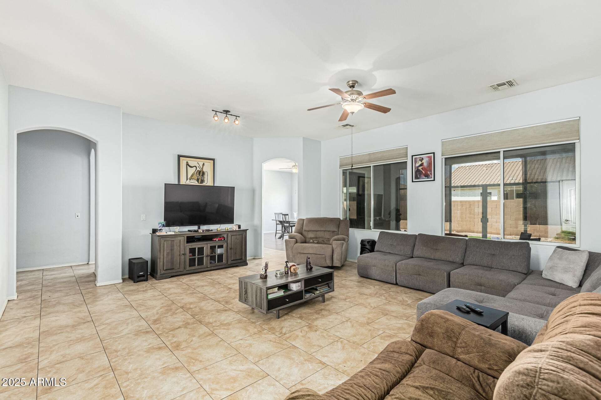 3318 West Latona Road Laveen, AZ 85339 - Photo 3 of 26 a living room with furniture and a flat screen tv