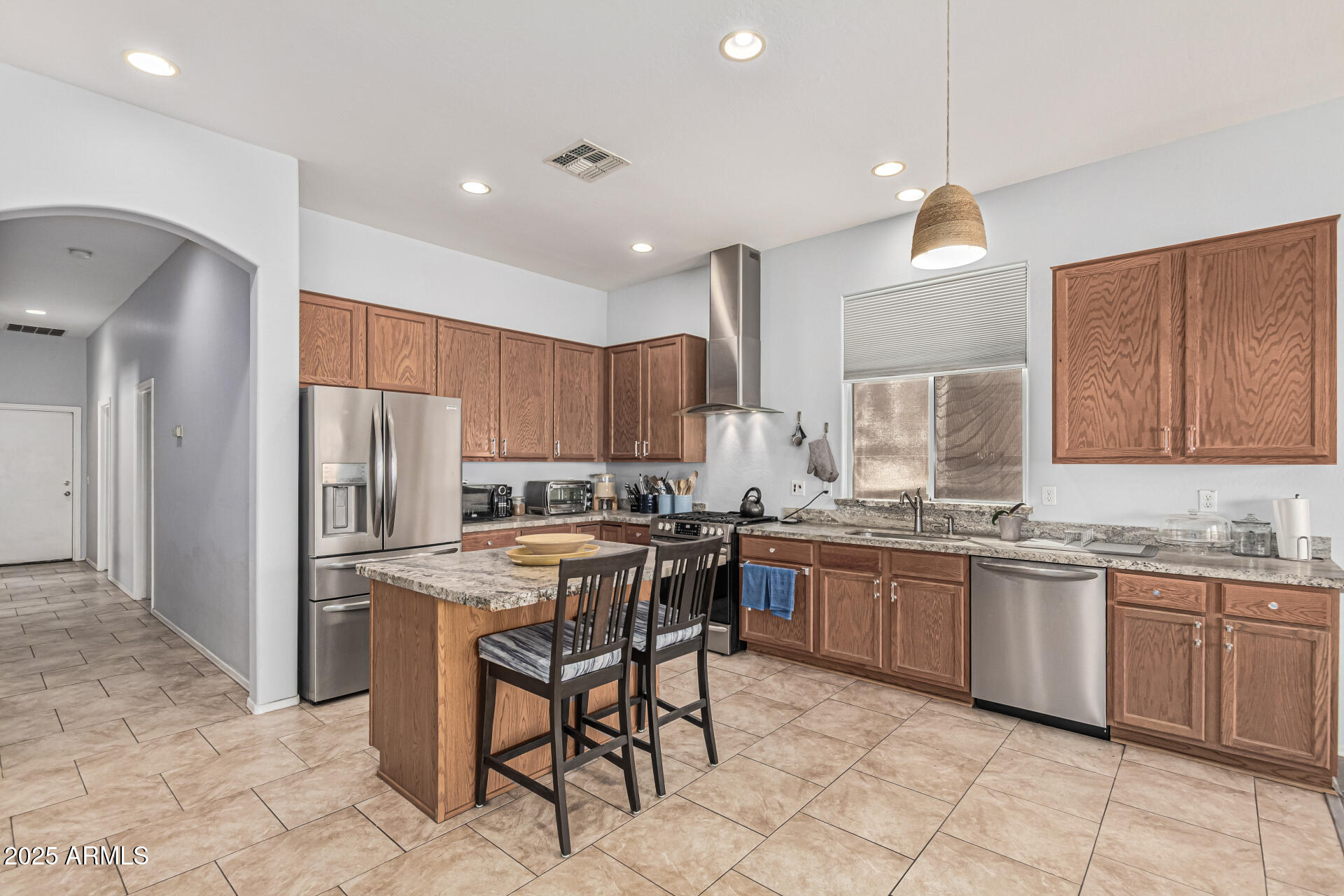 3318 West Latona Road Laveen, AZ 85339 - Photo 8 of 26 a kitchen with appliances cabinets and furniture