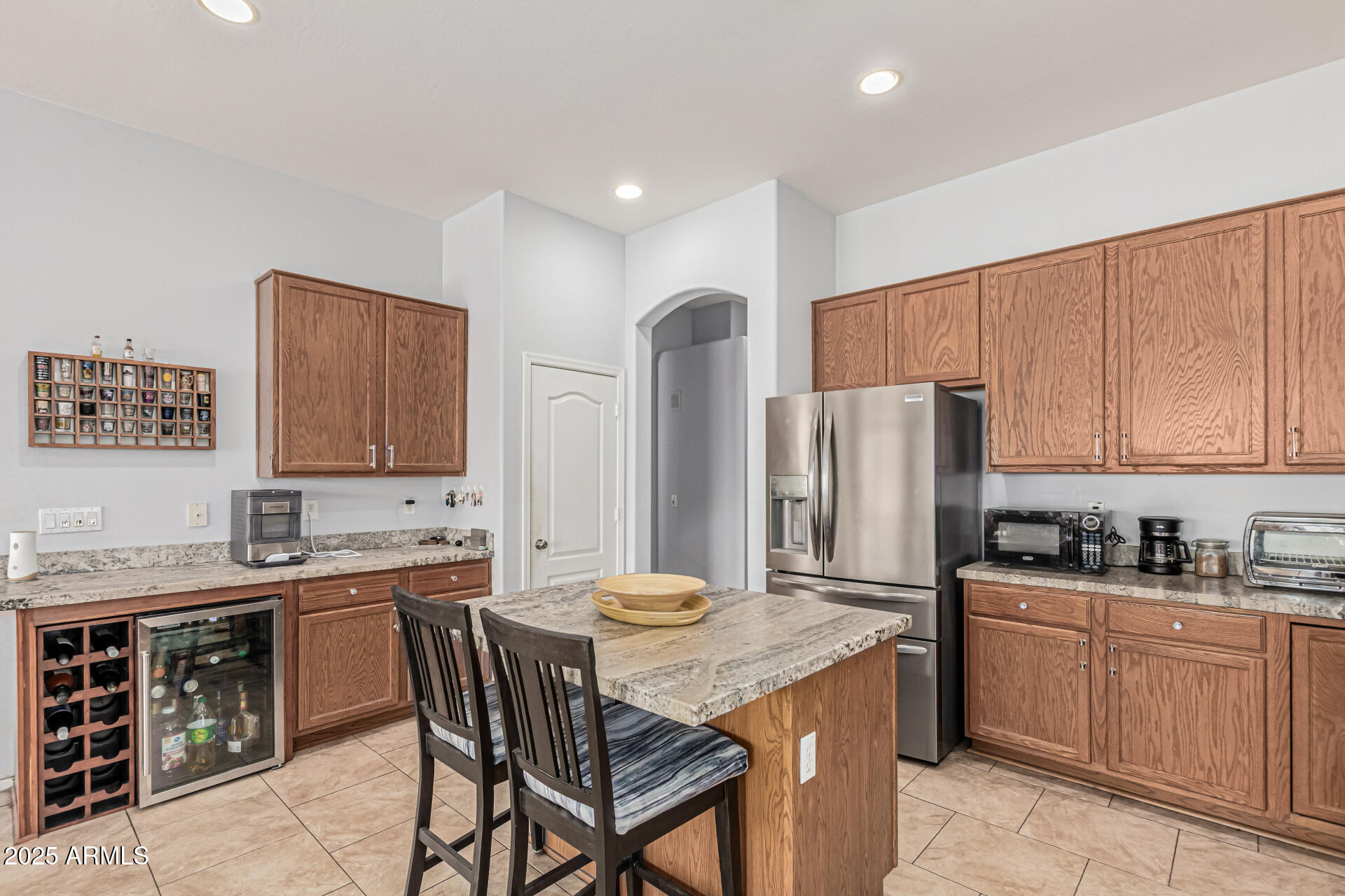 3318 West Latona Road Laveen, AZ 85339 - Photo 9 of 26 a kitchen with stainless steel appliances granite countertop a sink stove and refrigerator