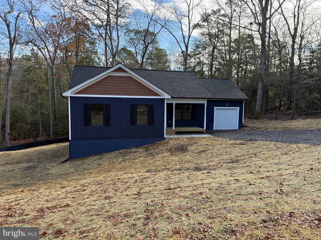 161 Walnut Street Kilmarnock, VA 22482 - Photo 2 of 4 a house with trees in the background