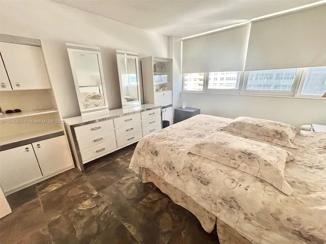 a spacious bedroom with a bed and window