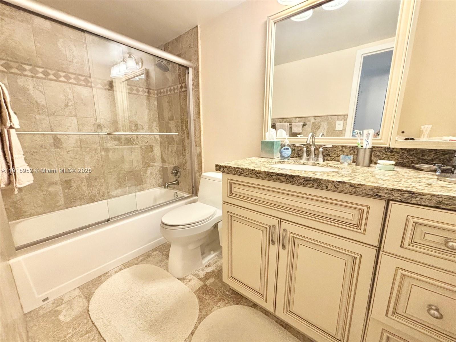 2030 South Ocean Drive, Unit 521 Hallandale Beach, FL 33009 - Photo 12 of 20 a bathroom with a granite countertop sink toilet and shower