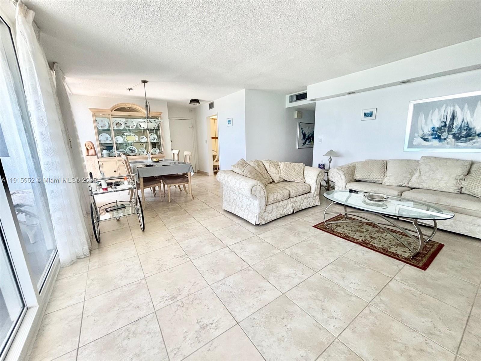 2030 South Ocean Drive, Unit 521 Hallandale Beach, FL 33009 - Photo 8 of 20 a living room with furniture and a table