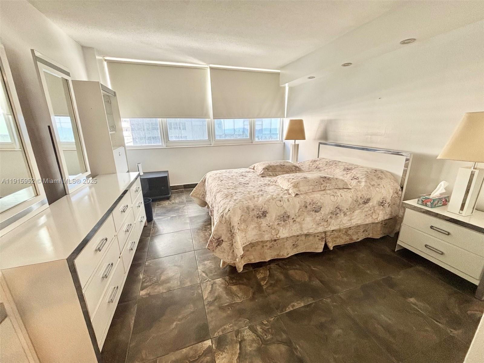 2030 South Ocean Drive, Unit 521 Hallandale Beach, FL 33009 - Photo 10 of 20 a bedroom with a bed and wooden floor