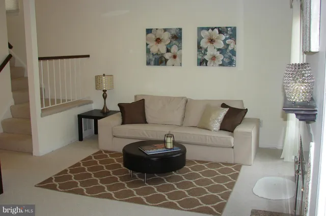 a living room with furniture a couch and wall painting