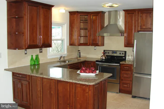 a kitchen with a stove a sink and a refrigerator
