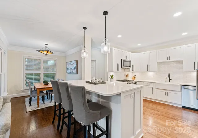 a large kitchen with a table and chairs
