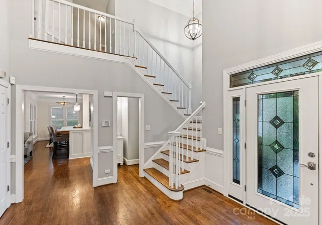a view of entryway and hall with wooden floor