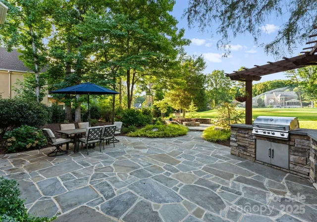 an outdoor sitting area with swimming pool and green space