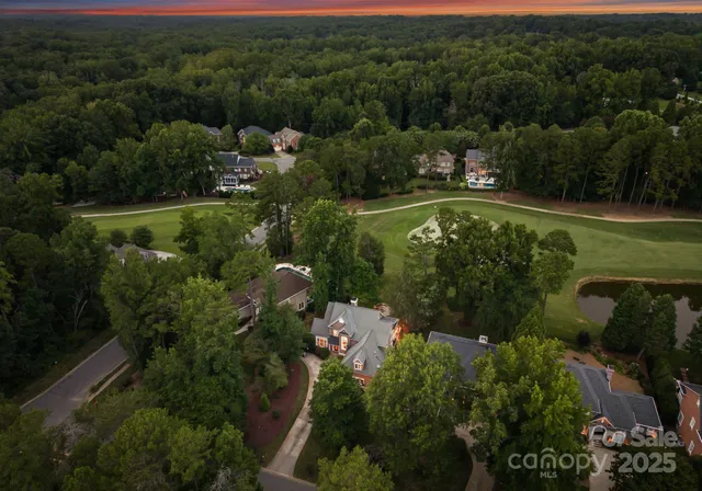 an aerial view of a houses with a yard