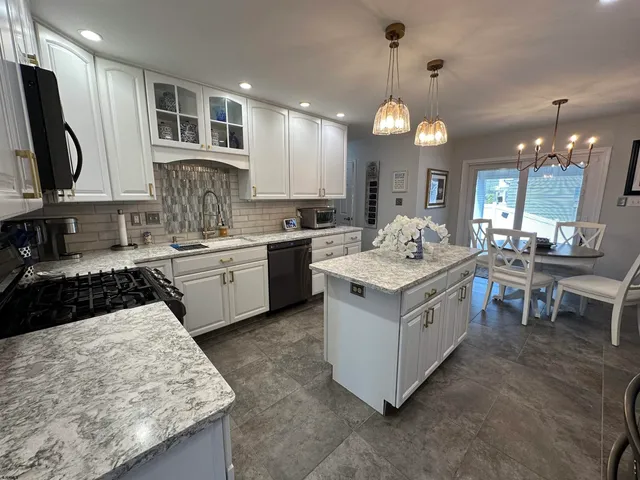a kitchen with a stove sink and a refrigerator