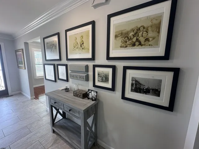 a living room with furniture and a painting on the wall