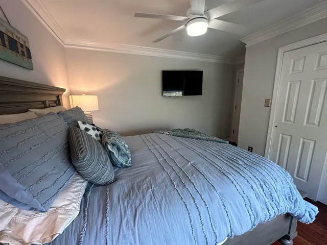 a bedroom with a bed and a flat screen tv