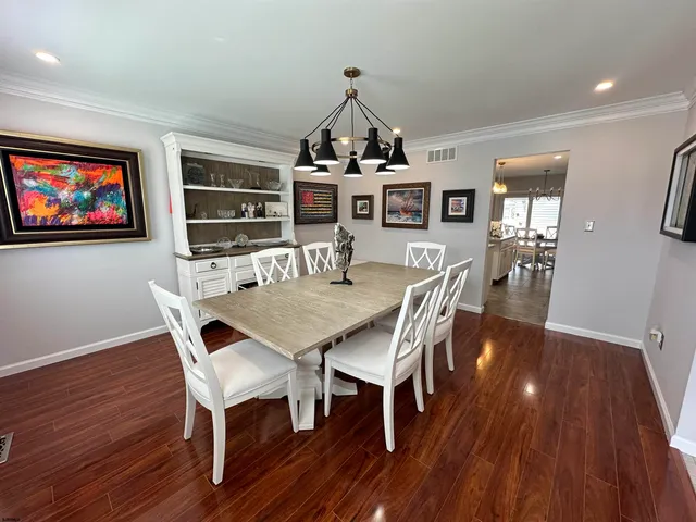 a view of a dining room with furniture wooden floor and chandelier