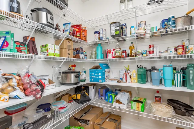 a spacious bedroom with a bed and a chandelier