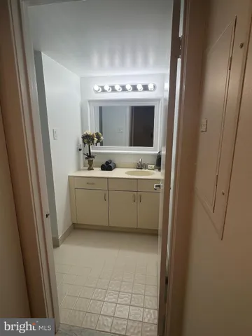 a bathroom with mirror sink and toilet