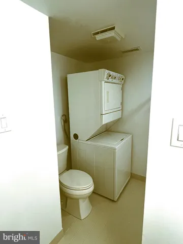 a white toilet sitting next to a white sink