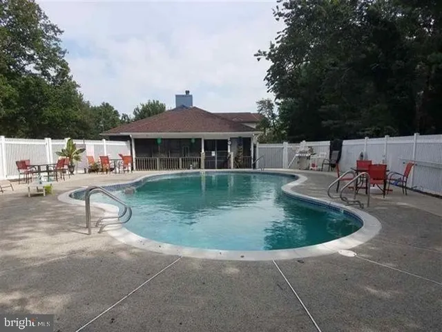 a view of a house with swimming pool and sitting area