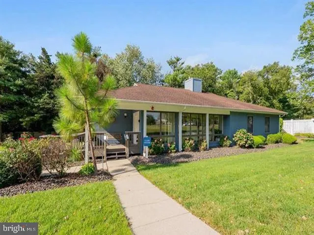 a view of a house with a yard patio and fire pit