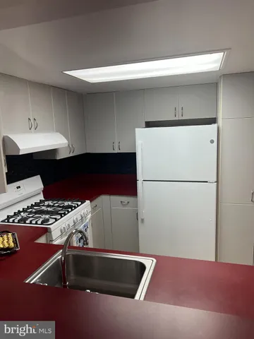a kitchen with a refrigerator and a stove