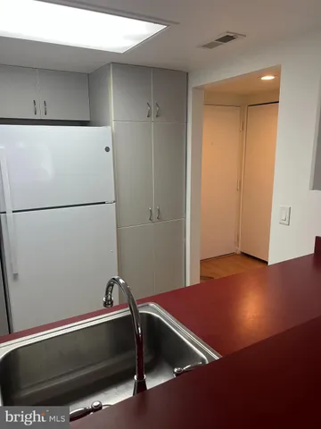 a room with a wooden floor and white walls